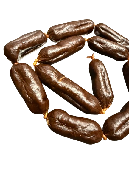A group of dehydrated beef sausage dog treats arranged on a surface